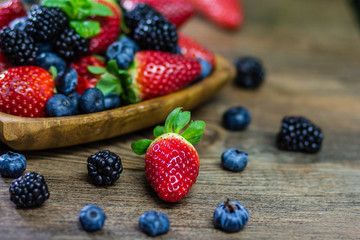Mix Berries strawberries, blueberries, blackberries on Wooden Background. Summer Organic Berry over Wood. Agriculture, Gardening