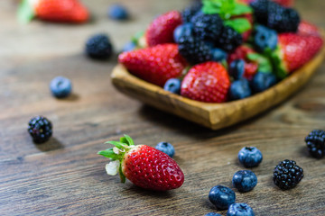 Mix Berries strawberries, blueberries, blackberries on Wooden Background. Summer Organic Berry over Wood. Agriculture, Gardening