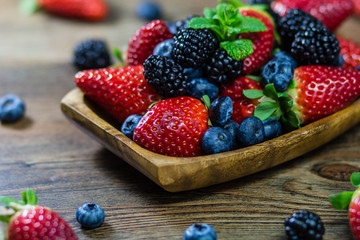 Mix Berries strawberries, blueberries, blackberries on Wooden Background. Summer Organic Berry over Wood. Agriculture, Gardening
