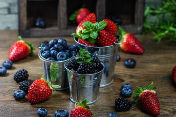 Mix Berries strawberries, blueberries, blackberries on Wooden Background. Summer Organic Berry over Wood. Agriculture, Gardening