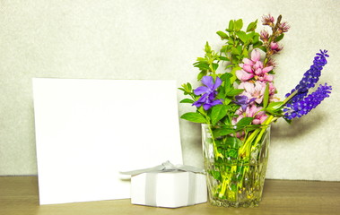 Blank card, present and flowers