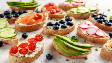 Homemade summer toast with cream cheese Smoked Salmon, Blueberries, Radish, Cucumber, Avocado and cress salad. Fresh healthy concept food.