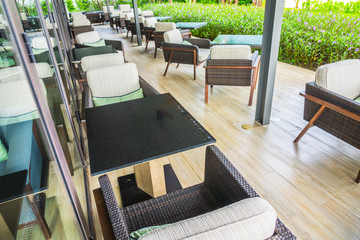 Tables and chairs in restaurant .