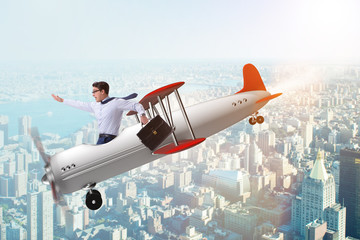 Businessman flying on vintage old airplane