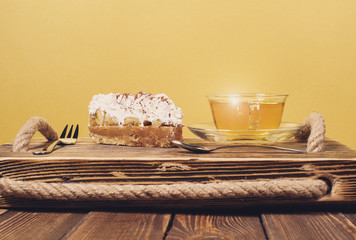 Naklejka na ściany i meble cake with tea on wooden desk