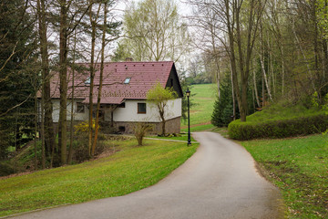 Cottage house with road path nature woods forest countryside landscape background