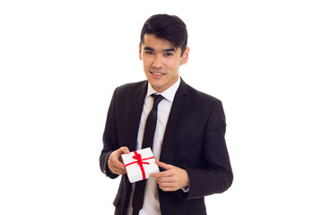 Young man in suit holding a present
