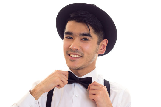 Young man with bow-tie, suspenders and hat