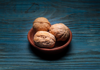 whole walnuts on rustic old wooden table