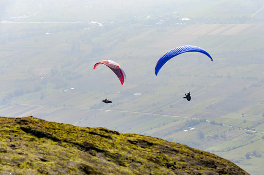 PRILEP, MACEDONIA - circa FEB, 2017: Paragliding over the valley in summer sunny day