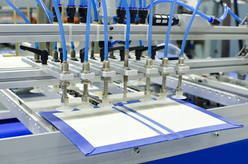 Fototapeta premium Hardcover for book in binding machine in offset pring production plant
