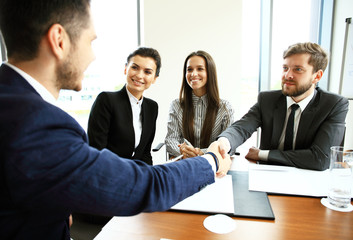 Business people shaking hands, finishing up a meeting.