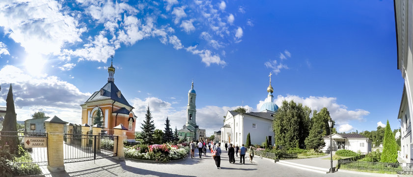KOZELSK, RUSSIA - circa AUGUST, 2016: Panorama of tourists visiting Church in honour of the Transfiguration in Optina Monastery, Russia