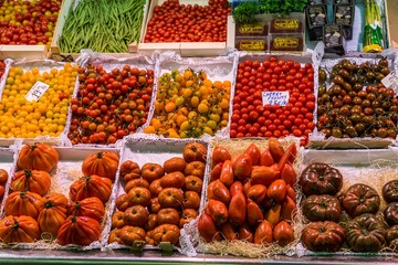 Famous La Boqueria market with vegetables and fruits in Barcelona, Spain