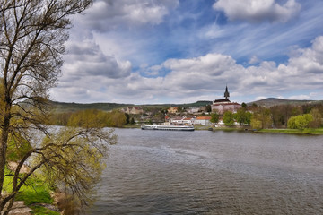 Fototapeta na wymiar cargo ship moored on river Elbe in spring Litomerice city in Czech republic