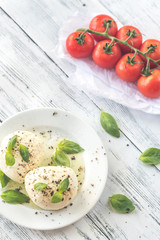 Mozzarella with cherry tomatoes and basil leaves
