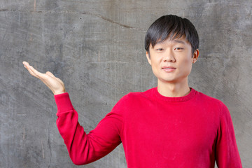 portrait of young asian man pointing