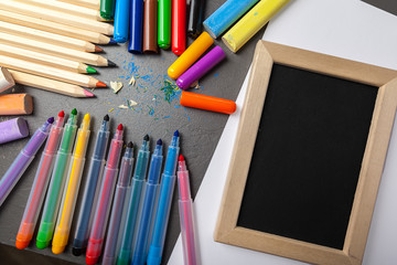 colorful pencils on gray stone background