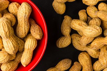 Peanuts in shell on dark background, close up