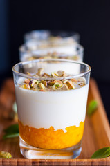 Three portions of Panna Cotta with pistachios