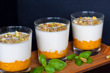 Three portions of Panna Cotta with pistachios