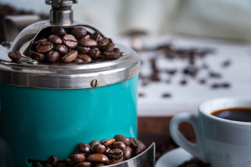 Closeup of coffee mill and cup of espresso. Cocept of coffee drinking tradition. Selective focus.