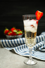 Refreshing cocktail with strawberry on gray table
