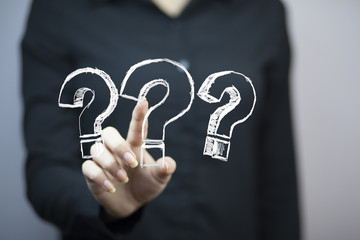 businesswoman touching question mark