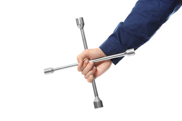Hand of auto mechanic with wheel wrench on white background