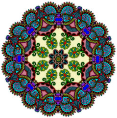 Circular very busy design with darker colors near the border with lighter center.  Many multi-colored design.
