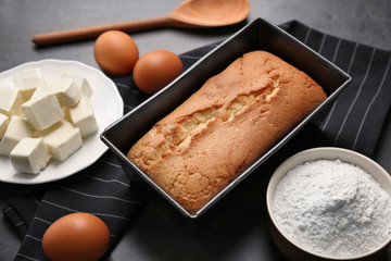 Tasty butter cake in baking dish on table