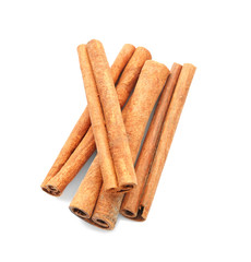 Heap of cinnamon sticks on white background