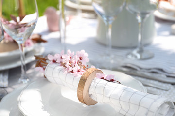 Napkin with branch of flowers on plate, closeup