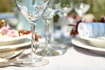 Wine glass on served festive table, closeup