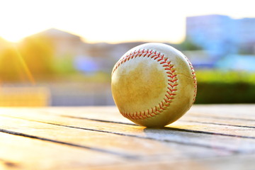 a ball for baseball on wooden bench