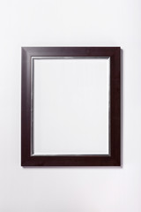 A walnut wood photo(picture) frame) isolated white.