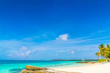 Beautiful tropical Maldives island with white sandy beach and sea .