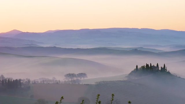 Panoramic video of a landscape of the Tuscan hills during sunrise with fog in the Val d'Orcia