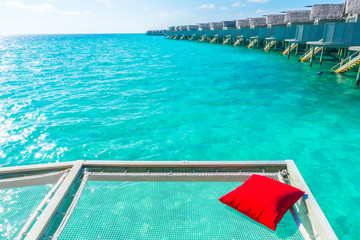 Vacation net seat in tropical Maldives island and beauty of the sea with the coral reefs .