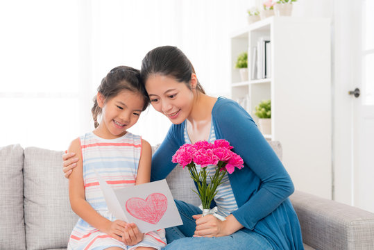 asian chinese woman holding bouquet with girl