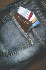 Closeup of VISA credit card and Passport in jeans