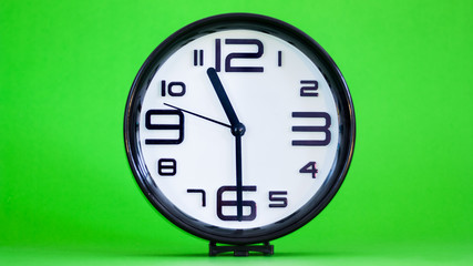 White wall clock green background