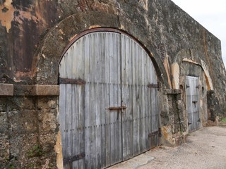 Old doors at the El Morro Fort, San Juan Puerto Rico Strong old doors at the very ground levels Fort San Felipe del Morro, Puerto Rico