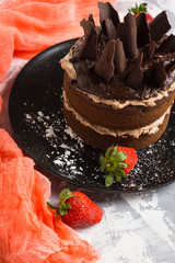 Chocolate cake on the rustic background. Selective focus.