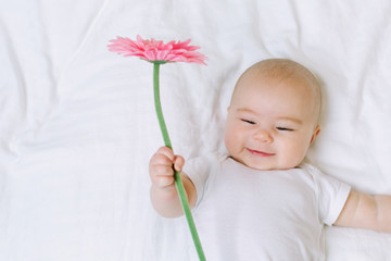Baby girl holding a flower