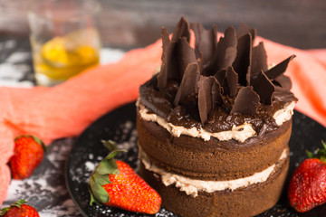 Chocolate cake on the rustic background. Selective focus.