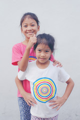 A pair of sisters smiling together