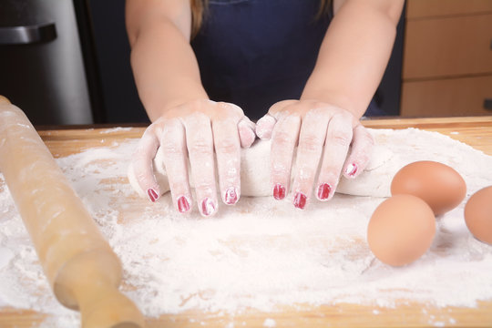 Woman hands kneading dough.