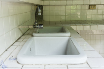 Old dirty sink and in the bathroom.