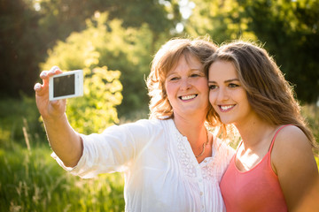 Senior mother with daughter selfie